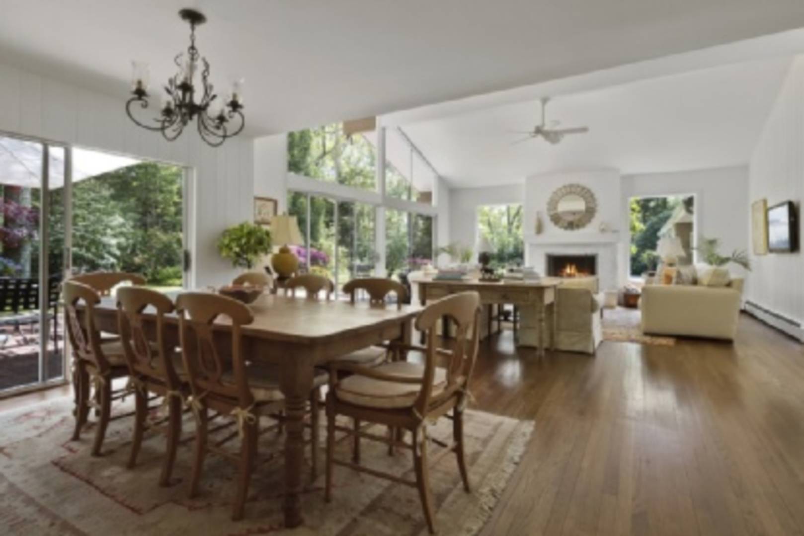182 Cove Hollow Road East Hampton, NY 11937 - Photo 2 of 14 a view of a dining room with furniture a chandelier and large windows