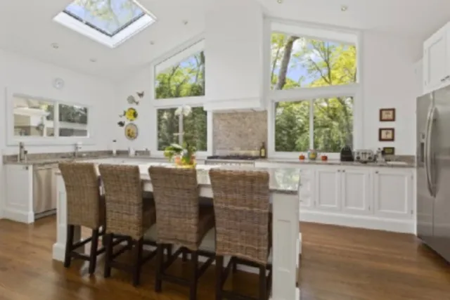 a dining table with chairs and window