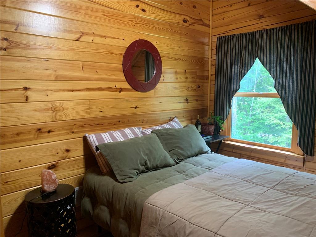 101 Cabin Road Normalville, PA 15469 - Photo 14 of 36 a bed sitting in a bedroom next to a window