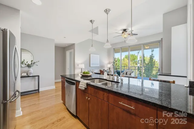 a kitchen with stainless steel appliances a sink a counter space and a window