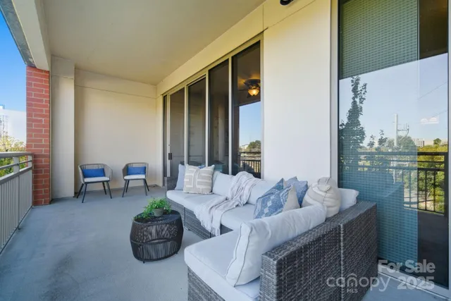 a living room with furniture and a floor to ceiling window