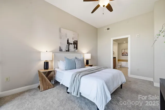 a bedroom with a bed and painting on the wall