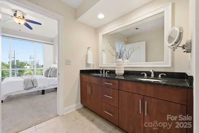 a bath room with a sink a mirror and a window