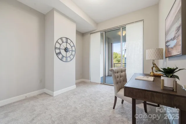 a view of a workspace with furniture and a window