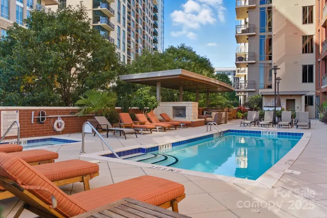 a view of swimming pool with outdoor seating and plants