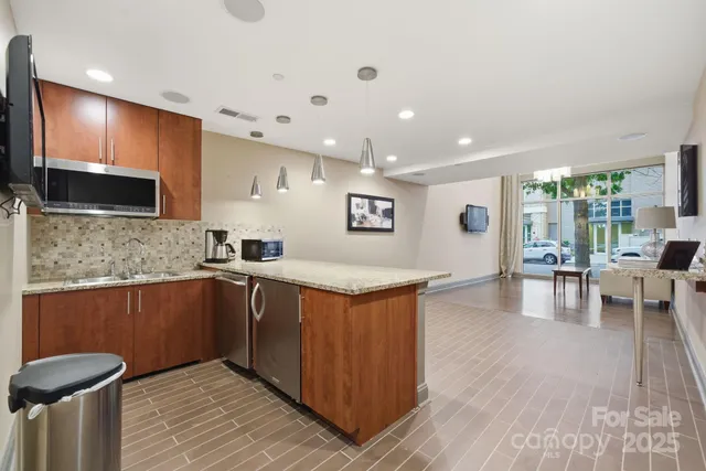 a kitchen with stainless steel appliances granite countertop a sink and cabinets