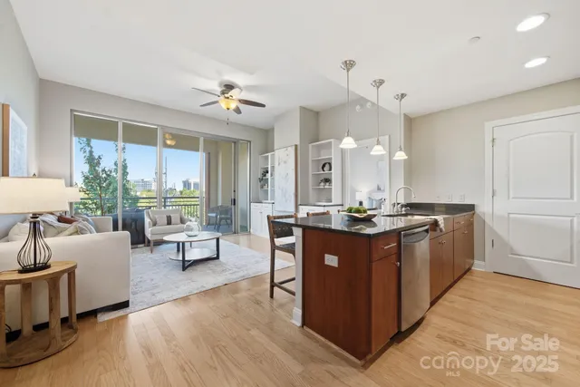 a large kitchen with kitchen island a sink a counter space and stainless steel appliances
