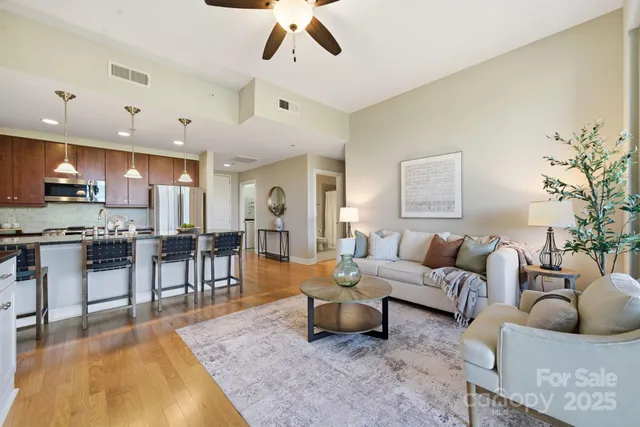 a living room with furniture and kitchen view