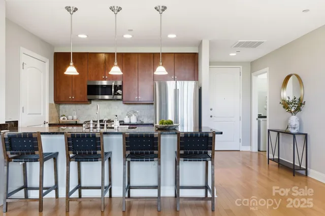a kitchen with kitchen island granite countertop a table and chairs in it