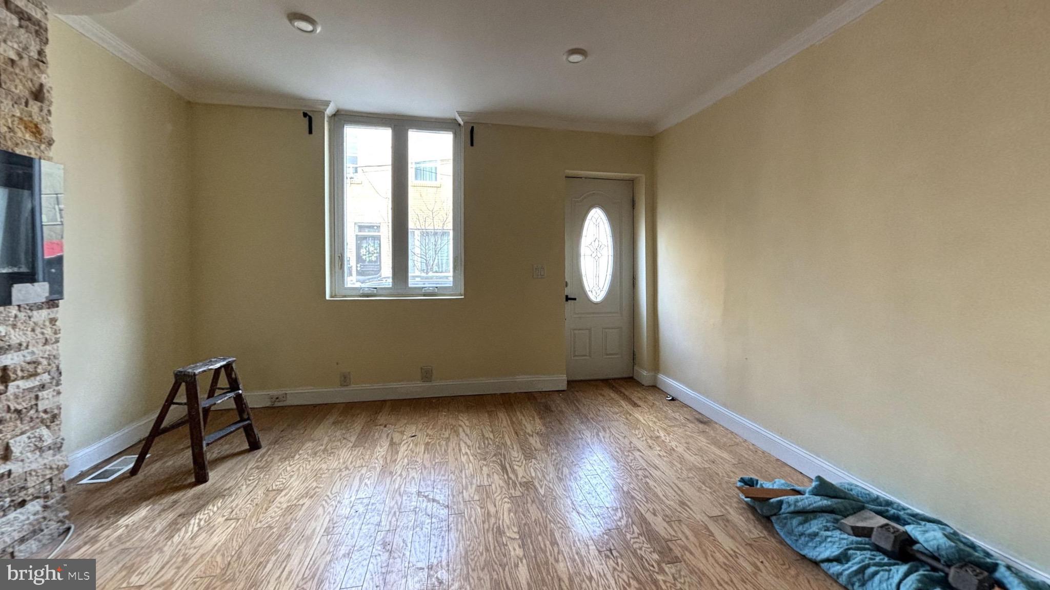2338 Cross Street Philadelphia, PA 19146 - Photo 2 of 7 an empty room with wooden floor and windows