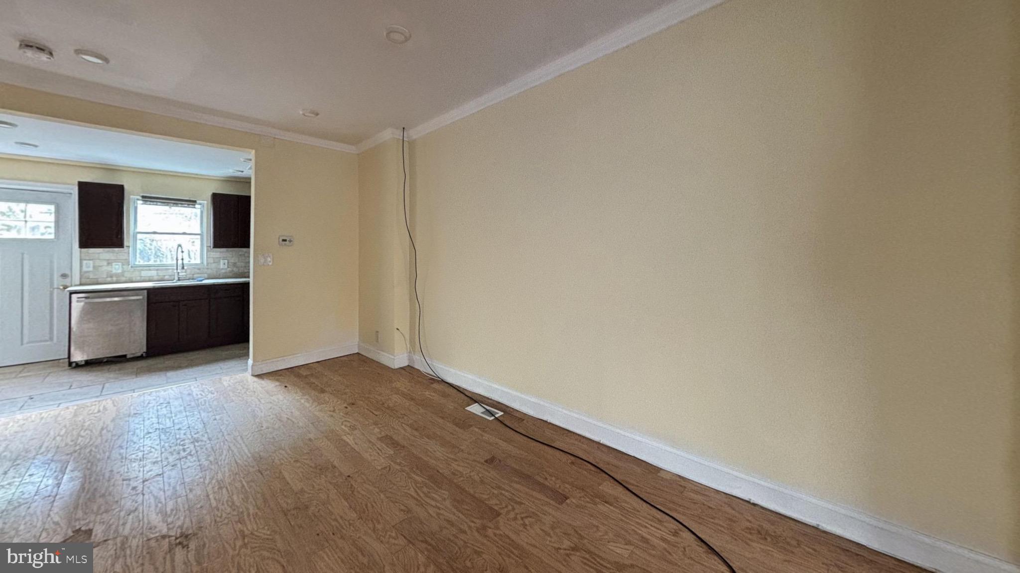 2338 Cross Street Philadelphia, PA 19146 - Photo 3 of 7 an empty room with wooden floor and kitchen