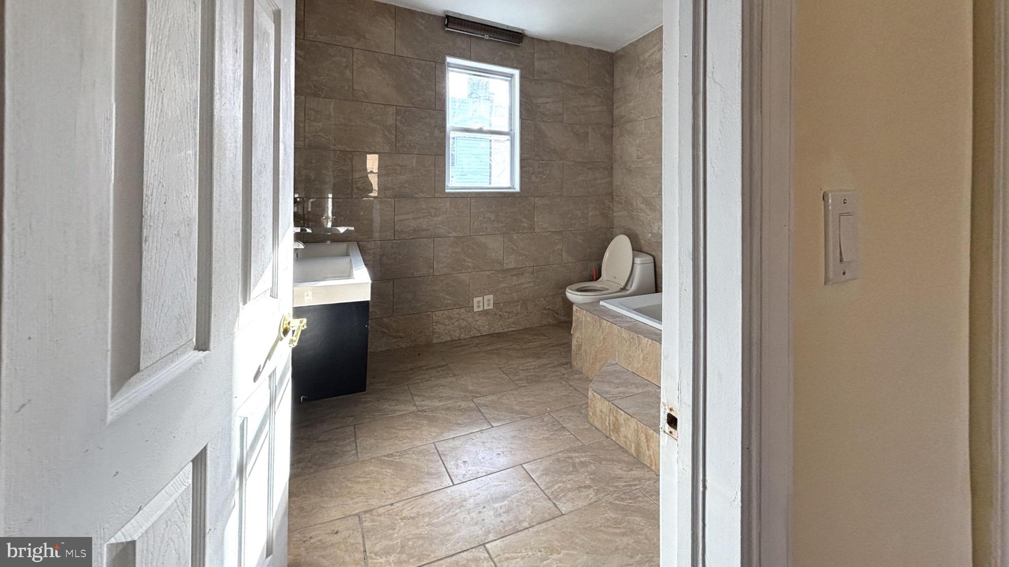 2338 Cross Street Philadelphia, PA 19146 - Photo 5 of 7 a bathroom with a sink a toilet and a mirror