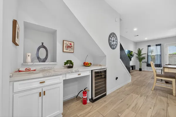 a kitchen with granite countertop white cabinets and white stainless steel appliances