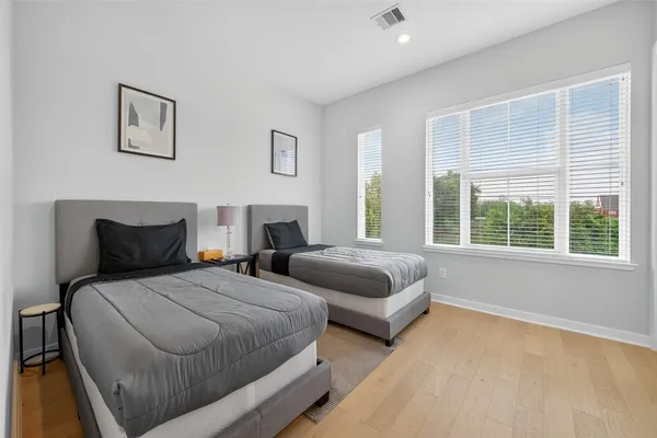 a bedroom with two beds and painting on the wall