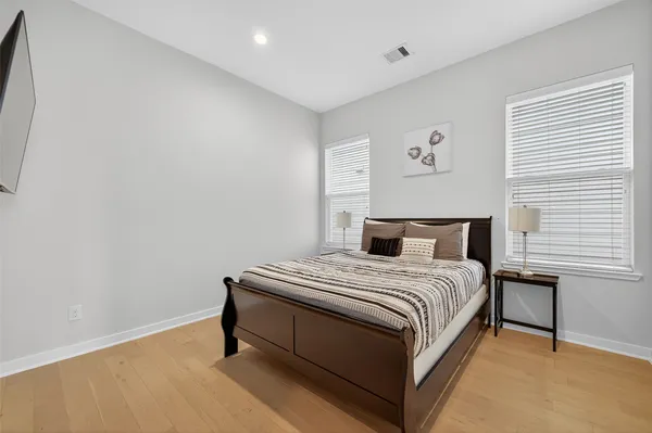 a bedroom with a bed and a flat screen tv