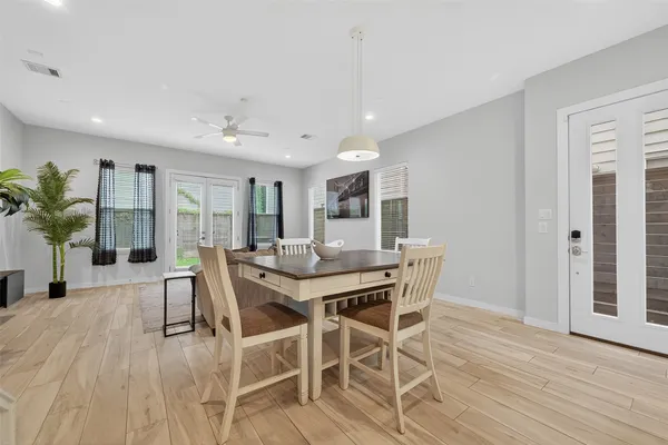 a view of a dining room with furniture and wooden floor