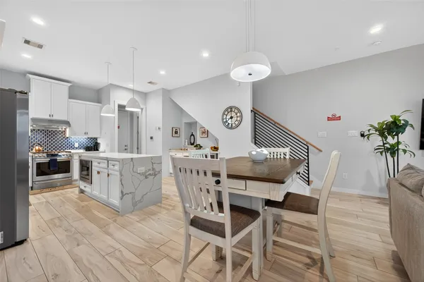 a view of a dining room with furniture and wooden floor
