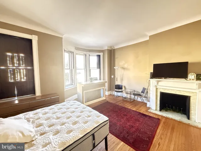 a bed room with a bed and a television