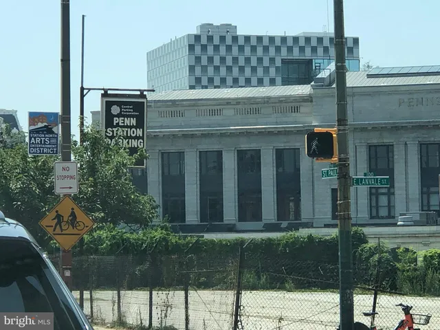 a front view of a building and car parked