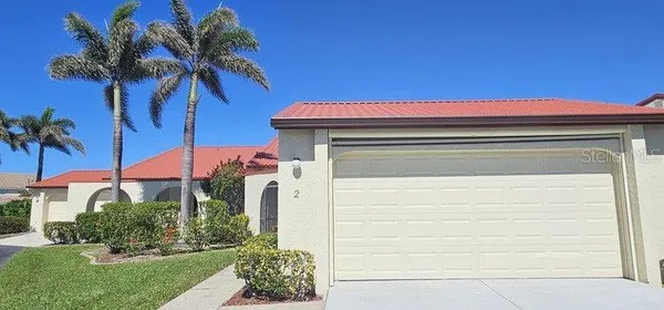 a yellow house with trees in front of it