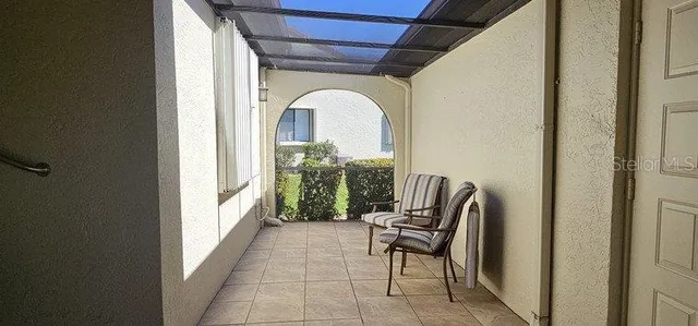 a dining room with furniture and large windows
