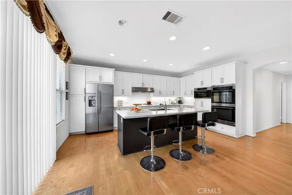 a kitchen with a sink appliances and cabinets
