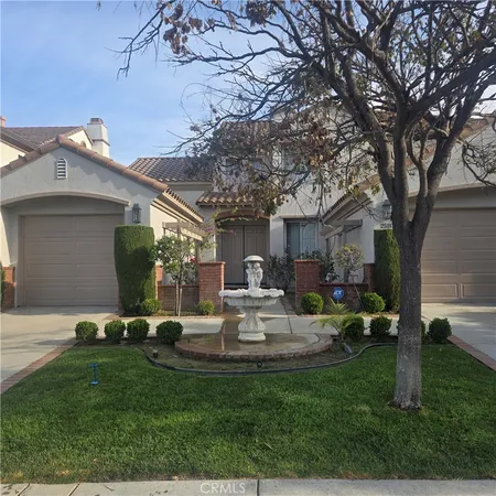 a view of a house with backyard sitting area and garden