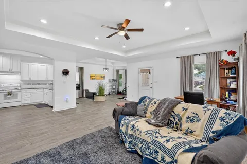 a living room with furniture and kitchen view