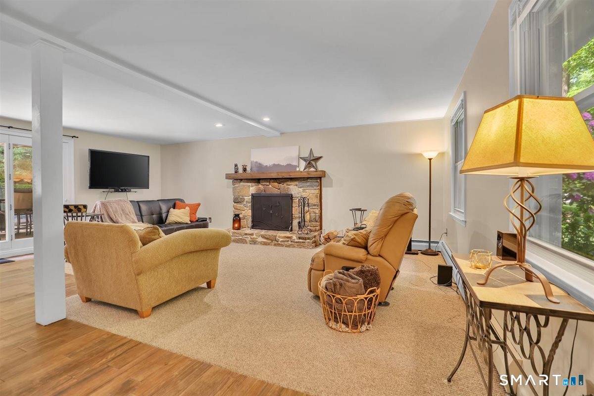122 Ridgeview Circle Guilford, CT 06437 - Photo 22 of 40 The family/recreation room offers wall-to-wall carpeting, recessed lights, and a cozy wood-burning fireplace with stone surround.