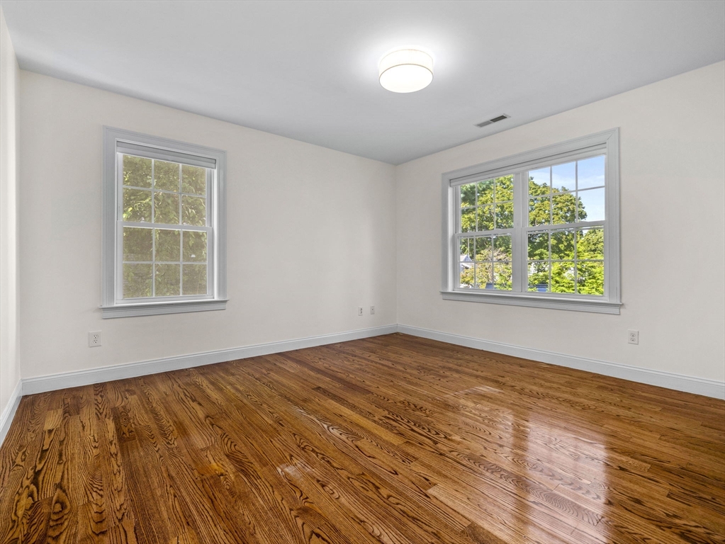7 Turner Road Wellesley, MA 02482 - Photo 23 of 36 a view of an empty room with wooden floor and a window