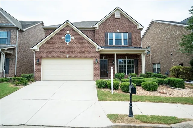 a front view of a house with garden
