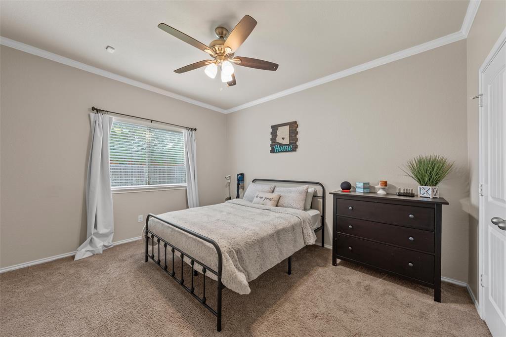 5801 Beckon Waco, TX 76708 - Photo 14 of 37 a bedroom with a bed and a chandelier