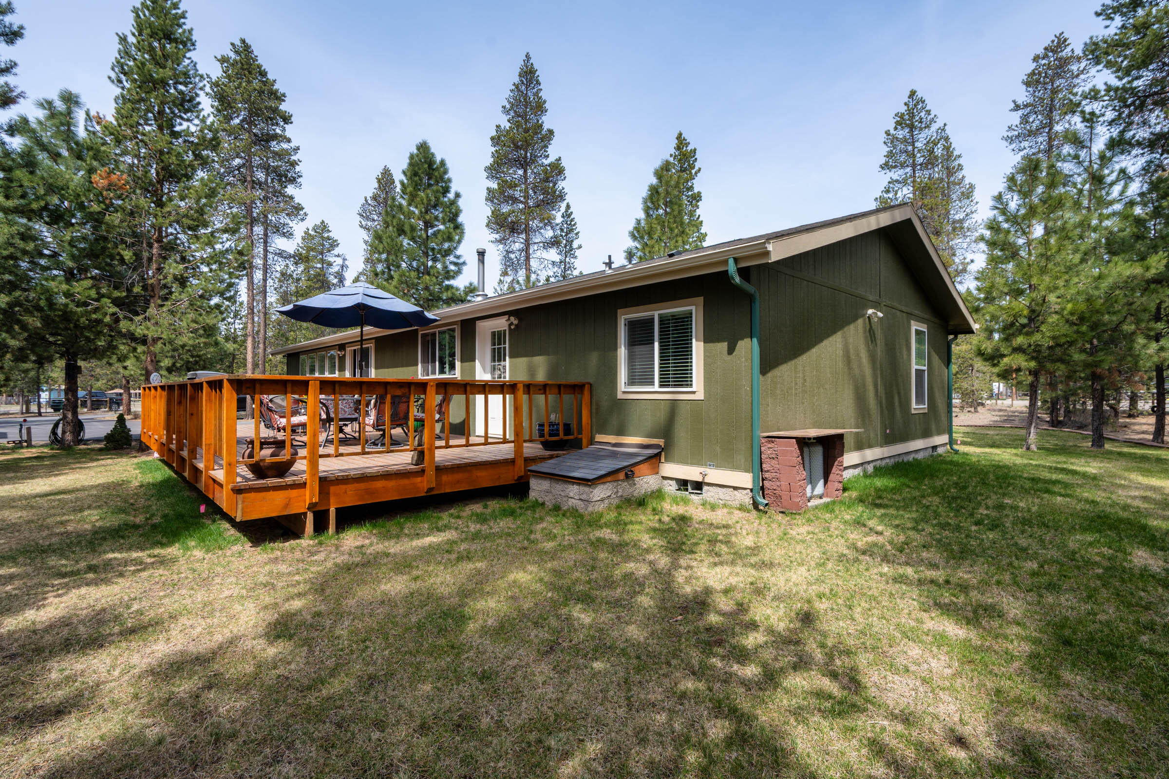 52648 Ammon Road La Pine, OR 97739 - Photo 33 of 44 a view of a house with a yard chairs and a table under an umbrella