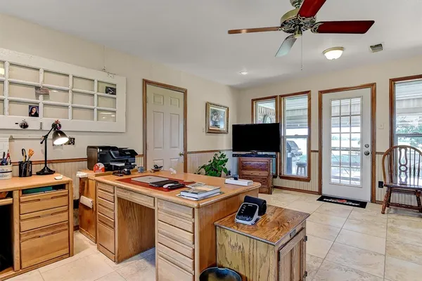 a room with furniture a flat screen tv and a window