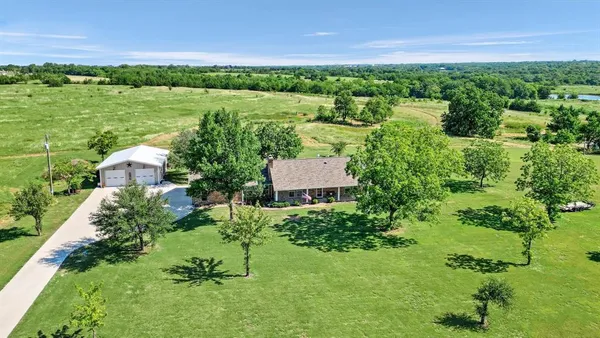 an aerial view of a house with a yard