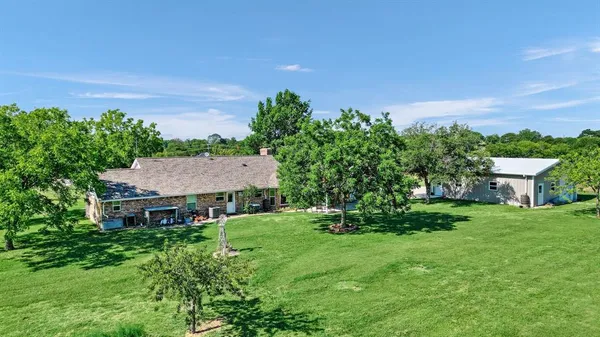 a view of a house with a yard balcony and sitting area