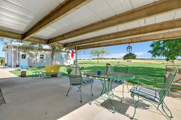 a view of a two chairs in the patio