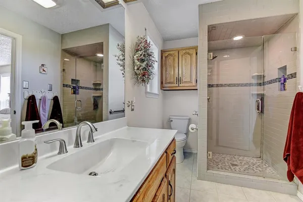 a bathroom with double vanity sink and a mirror
