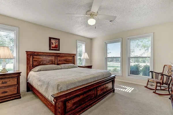 a bed sitting in a bedroom next to a window