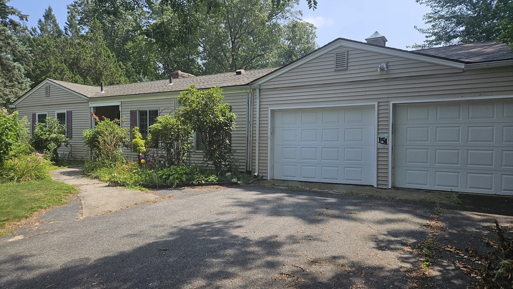 151 Wolf Swamp Road Longmeadow, MA 01106 - Photo 1 of 3 a front view of a house with a garden