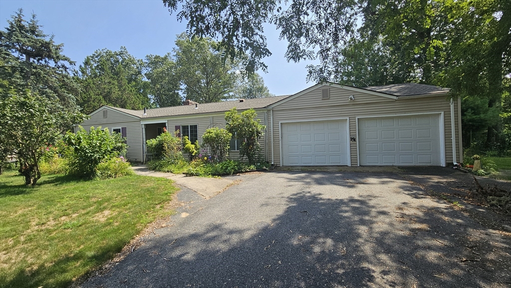151 Wolf Swamp Road Longmeadow, MA 01106 - Photo 2 of 3 a front view of a house with a yard and garage