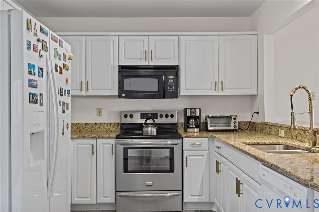 518 Rebel Ridge Road Colonial Heights, VA 23834 - Photo 15 of 44 a kitchen with stainless steel appliances granite countertop a stove a sink and a microwave