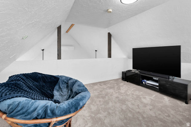 10686 South Covered Brg Cyn Road, Unit 14 Spanish Fork, UT 84660 - Photo 37 of 44 Attic space featuring sloped ceilings, exposed structural beams, and light gray carpeting