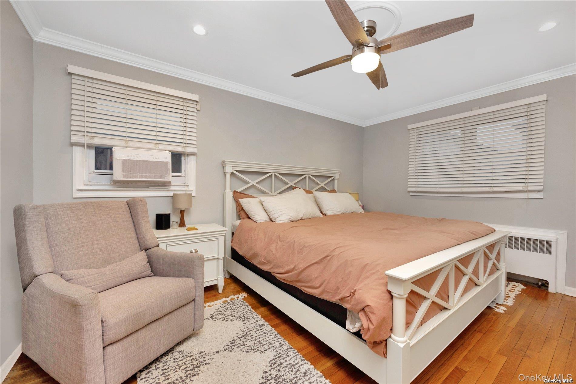 245 West Chester Street Long Beach, NY 11561 - Photo 25 of 31 Bedroom featuring hardwood / wood-style flooring, a ceiling fan, ornamental molding, radiator, and recessed lighting