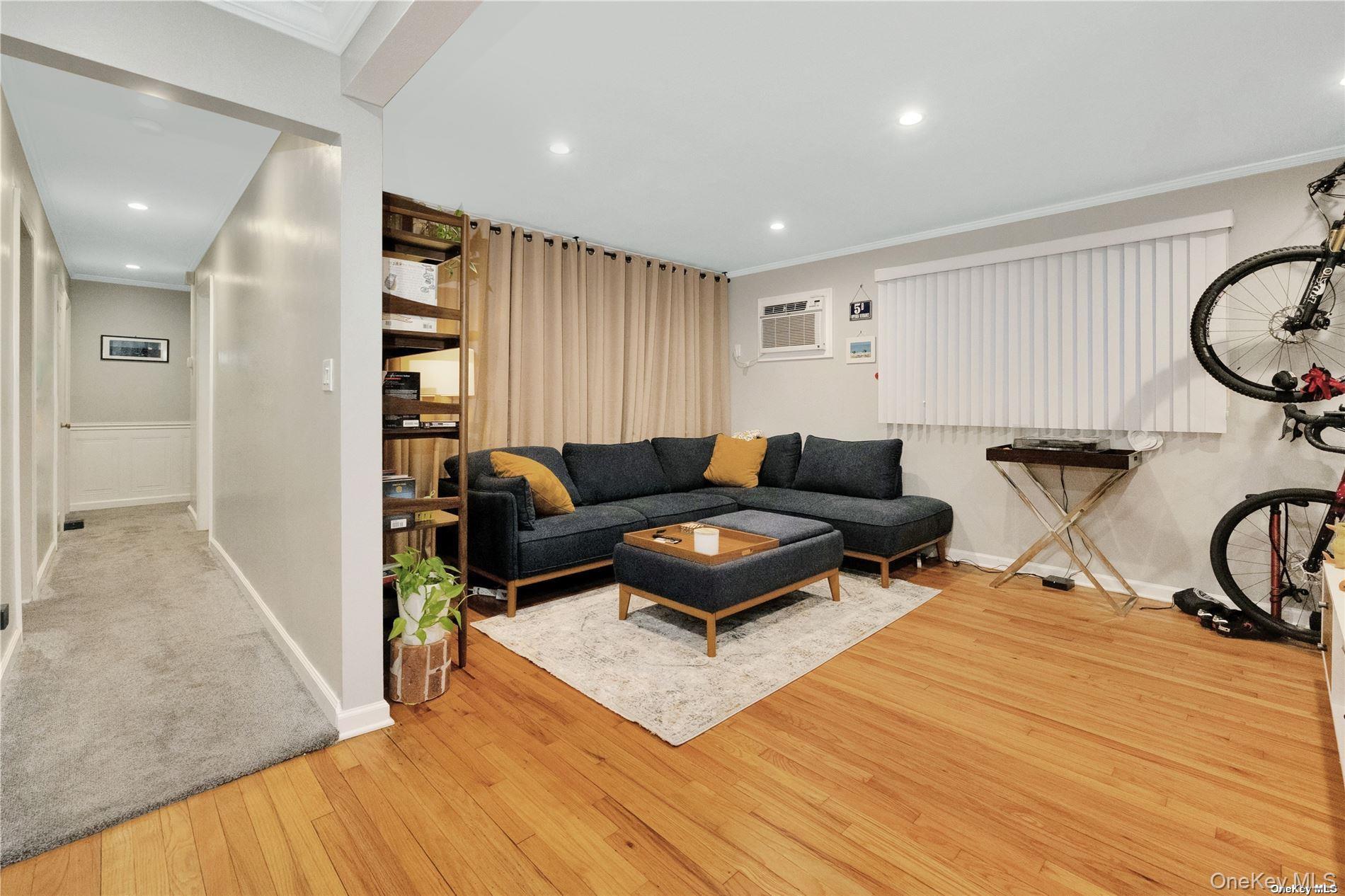 245 West Chester Street Long Beach, NY 11561 - Photo 27 of 31 Living room with crown molding, recessed lighting, light wood finished floors, and a wall mounted air conditioner