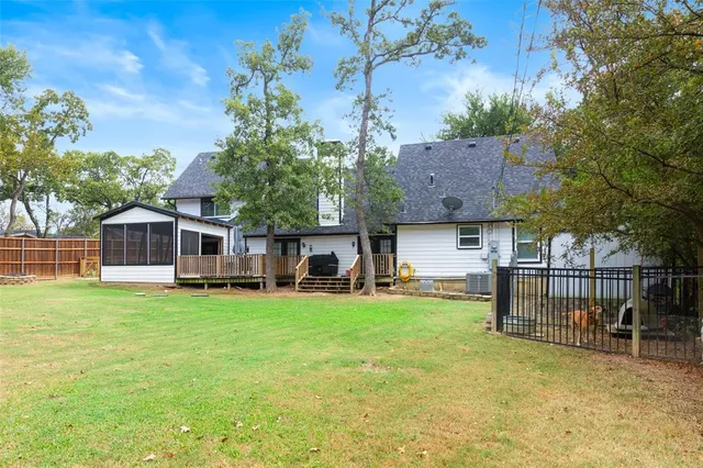 a view of a house with a yard and sitting area