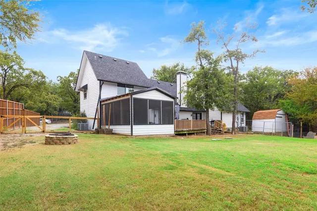 a view of a house with a yard and sitting area