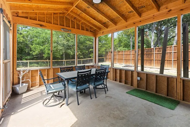 a dining room with furniture and a garden view