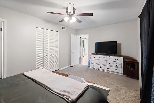 a living room with flat screen tv and furniture