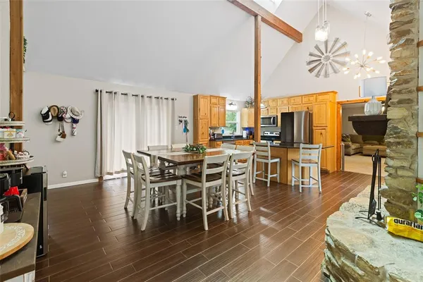 a dining room with furniture a couch and wooden floor